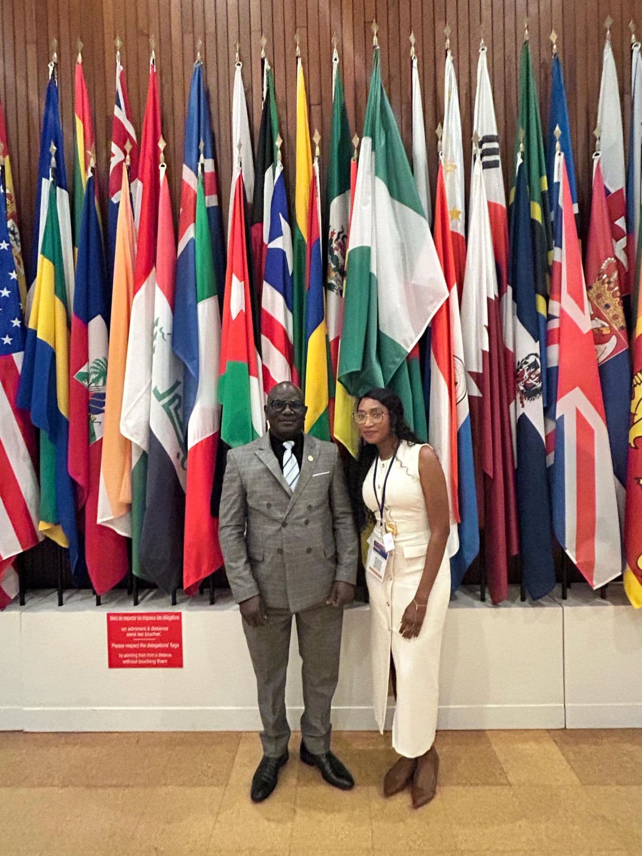 OSCN representatives standing before the delegation flags at UNESCO headquarters